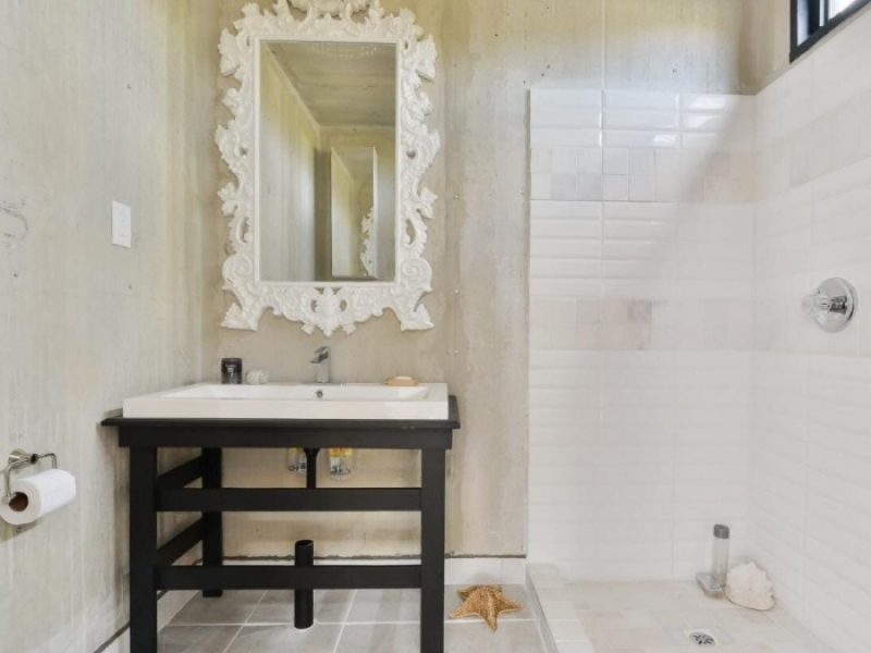 Contenedor de envío convertido en loft ecológico - Original lavabo con espejo artesanal en el baño.