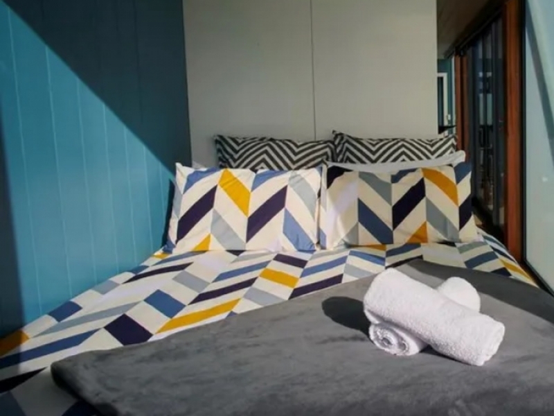 Maxi Apartment Pod - Conversión de contenedores de envío en Nueva Zelanda - Una cama doble que invita al descanso.